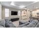 Open living space with sleek furniture, a large TV, and a view of the kitchen and dining area at 8878 Sw 103Rd Cir, Ocala, FL 34481