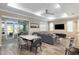Open floor plan featuring a living area with neutral furniture, a dining space, and access to the outdoor patio at 8878 Sw 103Rd Cir, Ocala, FL 34481