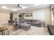 Living room with comfortable seating, large windows, and a view into the dining area and outdoor space at 8878 Sw 103Rd Cir, Ocala, FL 34481