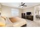 Serene main bedroom with neutral tones, a ceiling fan, and ample closet space at 8878 Sw 103Rd Cir, Ocala, FL 34481