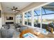 Spacious enclosed patio featuring comfortable seating, a fireplace, and scenic backyard views at 8878 Sw 103Rd Cir, Ocala, FL 34481