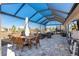 Outdoor patio with a dining table, seating area, and hot tub, perfect for relaxation and entertaining guests at 8878 Sw 103Rd Cir, Ocala, FL 34481