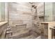 Walk-in shower featuring brown tiled walls, a built-in shelf, and dual shower heads at 8878 Sw 103Rd Cir, Ocala, FL 34481