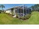 Expansive backyard featuring a screened lanai, lush landscaping, and a well-manicured lawn, ideal for outdoor enjoyment at 8904 Sw 84Th Cir, Ocala, FL 34481