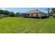 Large backyard featuring lush green grass, mature trees, and a screened lanai, offering a peaceful and private outdoor oasis at 8904 Sw 84Th Cir, Ocala, FL 34481