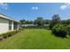Spacious backyard with a lush lawn, mature landscaping, and a screened patio, perfect for outdoor activities and relaxation at 8904 Sw 84Th Cir, Ocala, FL 34481