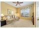 Comfortable bedroom with yellow walls, neutral carpet, and a window with decorative valance at 8904 Sw 84Th Cir, Ocala, FL 34481