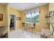 Inviting breakfast nook with a glass table and high top chairs, bathed in natural light from the large window at 8904 Sw 84Th Cir, Ocala, FL 34481