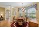 Comfortable dining room with wood flooring, a chandelier, and plenty of natural light at 8904 Sw 84Th Cir, Ocala, FL 34481