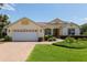 Charming single-story home featuring a brick driveway, manicured landscaping, and an attached two-car garage at 8904 Sw 84Th Cir, Ocala, FL 34481