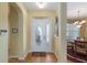 Inviting foyer with hardwood floors, view of dining room, and leaded glass front door at 8904 Sw 84Th Cir, Ocala, FL 34481