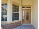 Charming front entrance with decorative leaded glass door, sidelight, and accent windows at 8904 Sw 84Th Cir, Ocala, FL 34481