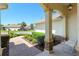 Inviting covered front porch with brick pathway, landscaped yard, and a comfortable rocking chair at 8904 Sw 84Th Cir, Ocala, FL 34481