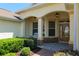 Detailed view of a charming home entrance featuring manicured landscaping and a brick pathway leading to the front door at 8904 Sw 84Th Cir, Ocala, FL 34481