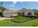 Charming single-story home featuring a brick driveway, manicured landscaping, and a convenient attached two-car garage at 8904 Sw 84Th Cir, Ocala, FL 34481
