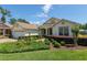 Inviting single-story home showcasing a brick driveway, lush landscaping, and a convenient two-car garage at 8904 Sw 84Th Cir, Ocala, FL 34481