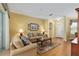 Comfortable living room with hardwood floors, sliders to the lanai, and beautiful accent lamps at 8904 Sw 84Th Cir, Ocala, FL 34481