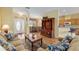 Open-concept living room shows front door, dining area, kitchen, and comfortable furniture at 8904 Sw 84Th Cir, Ocala, FL 34481