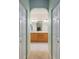 Main bathroom featuring an arched entry, dual sinks and a central mirror at 8904 Sw 84Th Cir, Ocala, FL 34481