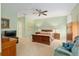 Spacious bedroom with neutral carpeting, a ceiling fan, and classic wood furniture at 8904 Sw 84Th Cir, Ocala, FL 34481