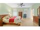 Comfortable bedroom with a ceiling fan, neutral carpet, and lots of natural light at 8904 Sw 84Th Cir, Ocala, FL 34481