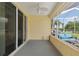 Covered patio with outdoor seating, offering a great view of the grassy backyard at 8904 Sw 84Th Cir, Ocala, FL 34481