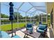 Charming screened patio offering a peaceful outdoor living space with comfortable seating and a serene backyard view at 8904 Sw 84Th Cir, Ocala, FL 34481
