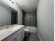 Nicely renovated bathroom with modern tiled walls, shower and vanity with white cabinets at 930 Nw 124Th Pl, Citra, FL 32113