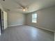 Bright bedroom featuring tiled floors, neutral paint, ceiling fan, and a window at 930 Nw 124Th Pl, Citra, FL 32113