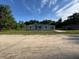 Charming single-story home with a well-maintained lawn and a clear blue sky at 930 Nw 124Th Pl, Citra, FL 32113