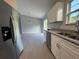 Modern kitchen featuring stainless steel appliances, granite countertops, and white cabinetry at 930 Nw 124Th Pl, Citra, FL 32113