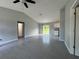 Open-concept living room with tiled floors and sliding glass doors to the backyard at 930 Nw 124Th Pl, Citra, FL 32113