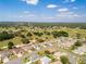 An aerial view showcases a neighborhood with lush landscaping and tree-lined streets at 9347 Se 137Th Street Rd, Summerfield, FL 34491
