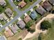 Stunning aerial view of a neighborhood along a golf course with well-maintained landscaping at 9347 Se 137Th Street Rd, Summerfield, FL 34491
