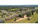 Aerial view of a neighborhood with homes adjacent to a scenic golf course at 9347 Se 137Th Street Rd, Summerfield, FL 34491