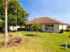 Beautiful backyard with lush green lawn and mature trees, and views of the house at 9347 Se 137Th Street Rd, Summerfield, FL 34491
