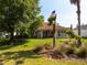 Spacious backyard with a well-manicured lawn and mature trees in a residential setting at 9347 Se 137Th Street Rd, Summerfield, FL 34491