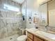 Elegant bathroom features a glass enclosed shower, granite counters and decorative elements at 9347 Se 137Th Street Rd, Summerfield, FL 34491