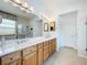 Bathroom featuring a glass-enclosed shower, dual sink vanity and an abundance of cabinets at 9347 Se 137Th Street Rd, Summerfield, FL 34491