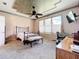 Spacious bedroom features a decorative ceiling, carpet and lots of natural light at 9347 Se 137Th Street Rd, Summerfield, FL 34491
