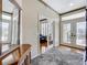 Inviting foyer with hardwood floors, a decorative mirror, and a view into the living area at 9347 Se 137Th Street Rd, Summerfield, FL 34491