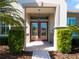 Elegant front door featuring decorative glass, sidelights, and a covered entrance at 9347 Se 137Th Street Rd, Summerfield, FL 34491