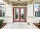 Close-up of elegant front doors with decorative glass panels and a welcoming entrance at 9347 Se 137Th Street Rd, Summerfield, FL 34491