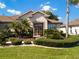Inviting home featuring mature landscaping and a beautiful front entrance with double glass doors at 9347 Se 137Th Street Rd, Summerfield, FL 34491