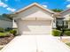 Attached two car garage with bright lighting and clean, well-maintained driveway at 9347 Se 137Th Street Rd, Summerfield, FL 34491