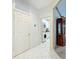 Hallway with white door to laundry room at 9347 Se 137Th Street Rd, Summerfield, FL 34491