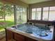 Enclosed lanai with hot tub and golf course view at 9347 Se 137Th Street Rd, Summerfield, FL 34491