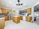 Spacious kitchen featuring stainless steel appliances, center island, and modern lighting at 9347 Se 137Th Street Rd, Summerfield, FL 34491