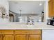 Kitchen sink features a countertop with cabinets and drawers, and a view of the living room at 9347 Se 137Th Street Rd, Summerfield, FL 34491