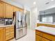 Kitchen featuring stainless steel appliances, wood cabinets and tiled backsplash at 9347 Se 137Th Street Rd, Summerfield, FL 34491